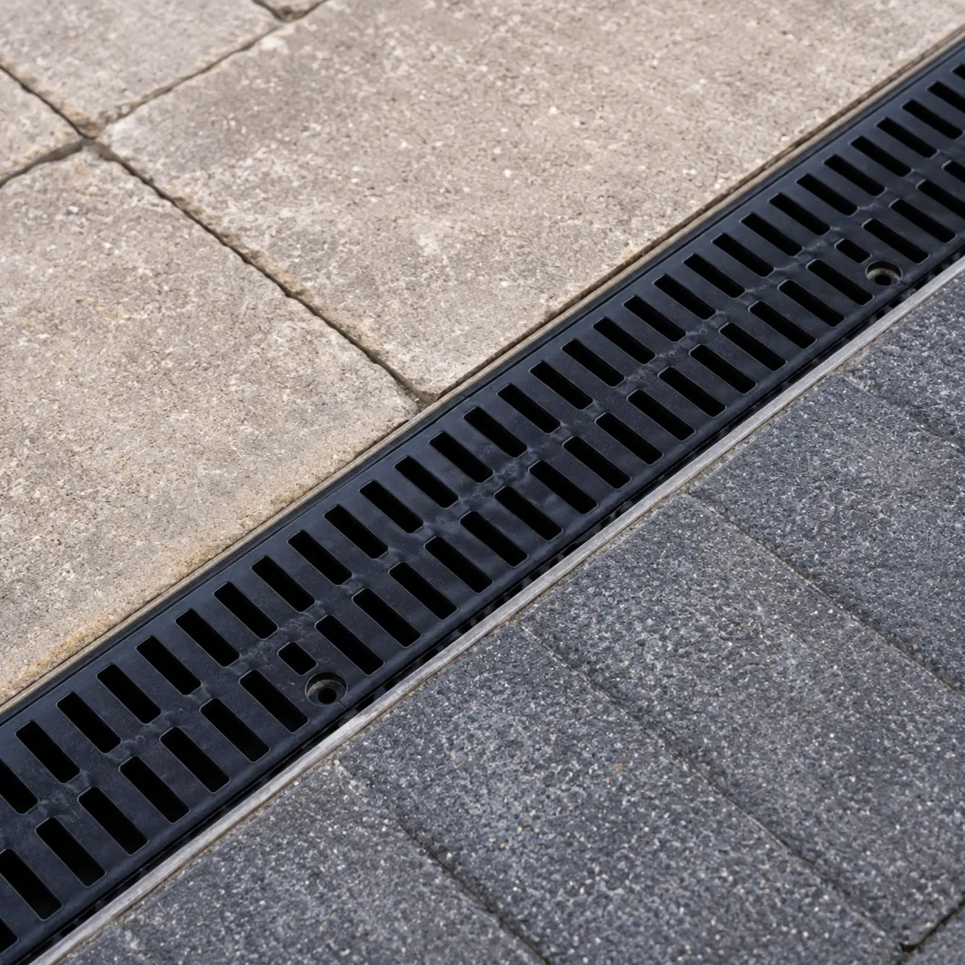 A drainage channel set into paving, the detail that protects Carlow driveways