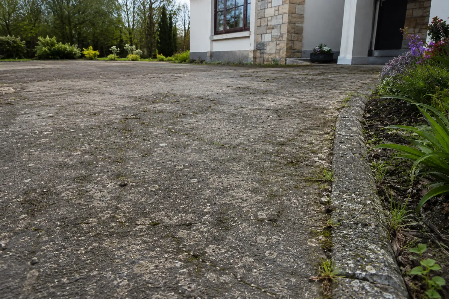 A worn driveway surface before resin was laid